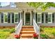Charming home featuring a brick entrance with well-maintained landscaping and a welcoming front porch at 1887 Steeplechase Dr, Rock Hill, SC 29732