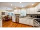 Bright kitchen with white cabinets, stainless steel appliances, granite countertops and a breakfast nook at 1887 Steeplechase Dr, Rock Hill, SC 29732