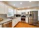 Well-lit kitchen boasting stainless steel appliances, granite countertops, and white cabinetry at 1887 Steeplechase Dr, Rock Hill, SC 29732