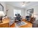 Comfortable home office with dual workstations, hardwood floors, and a ceiling fan at 1887 Steeplechase Dr, Rock Hill, SC 29732