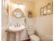Charming powder room with a pedestal sink, wainscoting, and decorative fixtures at 1887 Steeplechase Dr, Rock Hill, SC 29732