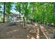 Large backyard featuring a picnic table and a treehouse surrounded by lush trees at 2205 Gallberry Ln, Waxhaw, NC 28173