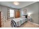 Cozy bedroom features gray walls, carpet, window and a small wardrobe at 2205 Gallberry Ln, Waxhaw, NC 28173