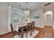 Dining area with a chandelier, hardwood floors, and bright windows with natural light at 2205 Gallberry Ln, Waxhaw, NC 28173