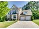 Beautiful two-story home with stone accents, manicured lawn, and an attached two-car garage at 2205 Gallberry Ln, Waxhaw, NC 28173