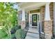 Inviting front entrance with a decorative wreath and stone pillars, creating a welcoming atmosphere at 2205 Gallberry Ln, Waxhaw, NC 28173