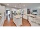 Spacious kitchen with white cabinets, hardwood floors, granite counters, and a large kitchen island at 2205 Gallberry Ln, Waxhaw, NC 28173