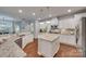 Bright and spacious kitchen featuring granite counters, white cabinets, an island and stainless appliances at 2205 Gallberry Ln, Waxhaw, NC 28173