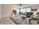 Spacious living room with vinyl floors, windows, gray couch, and a TV at 2205 Gallberry Ln, Waxhaw, NC 28173