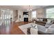 Spacious living room with fireplace, hardwood floors, and comfortable seating area at 2205 Gallberry Ln, Waxhaw, NC 28173