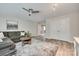 Spacious living room with vinyl floors, a gray couch, a coffee table, and a ceiling fan at 2205 Gallberry Ln, Waxhaw, NC 28173