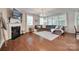 Cozy living room with hardwood floors, fireplace, large windows, and comfortable seating at 2205 Gallberry Ln, Waxhaw, NC 28173