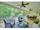 A charming porch featuring wood floors, ceiling fans, an outdoor seating area, and backyard views at 2205 Gallberry Ln, Waxhaw, NC 28173