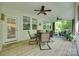 A charming porch featuring wood floors, multiple ceiling fans, and a dining table at 2205 Gallberry Ln, Waxhaw, NC 28173