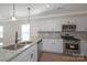 Modern kitchen with white cabinets, granite countertops, stainless steel appliances and eat in island with sink at 2207 Catawba Trace Dr, Catawba, NC 28609