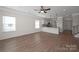 Open-concept living room featuring hardwood floors and a breakfast bar overlooking the modern white kitchen at 2207 Catawba Trace Dr, Catawba, NC 28609