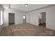 Spacious bedroom with tray ceiling, carpet, and ensuite bathroom with vanity and tile floors at 2207 Catawba Trace Dr, Catawba, NC 28609