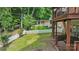 Home backyard with lush lawn, mature trees, and multi-level deck perfect for social gatherings at 2308 Blair House Ct, Charlotte, NC 28270