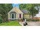Charming yellow home featuring a red door, bay window, and beautifully landscaped front yard at 2308 Blair House Ct, Charlotte, NC 28270