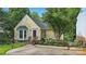 Charming yellow home featuring a red door, bay window, and beautifully landscaped front yard at 2308 Blair House Ct, Charlotte, NC 28270