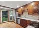 Kitchen with stainless steel appliances, wood cabinets, white countertops and bay window overlooking backyard at 2308 Blair House Ct, Charlotte, NC 28270