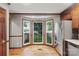 Bright kitchen features a bay window, stainless steel refrigerator, and beautiful hardwood floors at 2308 Blair House Ct, Charlotte, NC 28270