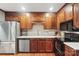 This kitchen is equipped with stainless steel appliances, wooden cabinets and tile backsplash at 2308 Blair House Ct, Charlotte, NC 28270