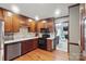 Traditional kitchen with wood cabinets, stainless steel appliances, and views of the living room at 2308 Blair House Ct, Charlotte, NC 28270