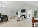 Bright living room boasts a fireplace, vaulted ceilings, neutral palette and seamless access to the outdoor deck at 2308 Blair House Ct, Charlotte, NC 28270