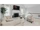 Inviting living room offers a fireplace, large windows and ample seating for relaxing or entertaining guests at 2308 Blair House Ct, Charlotte, NC 28270