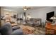 The open-concept living room has hardwood flooring, ceiling fan and comfortable seating at 251 Birch Tree Rd, Clover, SC 29710