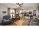 The open-concept living room has hardwood flooring, ceiling fan and comfortable seating at 251 Birch Tree Rd, Clover, SC 29710