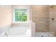 Well-lit bathroom with a soaking tub and separate glass shower, offering a spa-like experience at 265 Miramar Dr, York, SC 29745