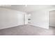 A spacious bedroom featuring neutral-toned walls, carpet, and two entry doors with an open doorway to the bathroom at 265 Miramar Dr, York, SC 29745