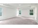 Spacious bedroom featuring plush carpet, tray ceiling, and natural light from three windows at 265 Miramar Dr, York, SC 29745