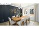 Inviting dining room featuring a long wood table, modern light fixture, and backyard views at 265 Miramar Dr, York, SC 29745