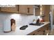 Bright kitchen featuring white countertops, tile backsplash, wood cabinets, and modern fixtures at 265 Miramar Dr, York, SC 29745