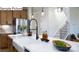 Modern kitchen featuring stainless steel appliances, a farmhouse sink, and an island with a marble countertop at 265 Miramar Dr, York, SC 29745