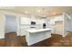 Modern kitchen featuring white cabinets, a center island, quartz countertops, and stainless steel appliances at 265 Miramar Dr, York, SC 29745