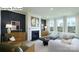 Elegant living room with a cozy fireplace, modern furnishings, and natural light pouring through large windows at 265 Miramar Dr, York, SC 29745