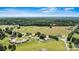 Panoramic aerial view showing the property's setting amidst rolling green fields and distant mountains at 3372 Lee Lawing Rd, Lincolnton, NC 28092