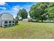 Expansive backyard featuring lush green grass and mature trees, perfect for outdoor activities at 3372 Lee Lawing Rd, Lincolnton, NC 28092