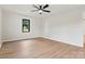 This bedroom features wood-look floors, neutral paint, a ceiling fan, and a window with a tree outside at 3372 Lee Lawing Rd, Lincolnton, NC 28092