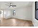 This bedroom features wood-look floors, neutral paint, a ceiling fan, and a window with a black frame at 3372 Lee Lawing Rd, Lincolnton, NC 28092
