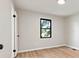 Bright bedroom featuring neutral walls, light-colored wood floors, and a window view at 3372 Lee Lawing Rd, Lincolnton, NC 28092