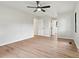 This bedroom features wood-look floors, neutral paint, a ceiling fan, and several doors leading to other rooms at 3372 Lee Lawing Rd, Lincolnton, NC 28092
