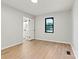 Clean bedroom with wood floors, bathroom access, and natural light from the window at 3372 Lee Lawing Rd, Lincolnton, NC 28092
