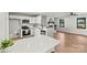 Modern kitchen opens to a living room with a brick fireplace at 3372 Lee Lawing Rd, Lincolnton, NC 28092