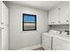 Functional laundry room with washer, dryer, and storage cabinets for convenience at 3372 Lee Lawing Rd, Lincolnton, NC 28092