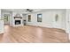 Bright living room with hardwood floors, white brick fireplace, and large windows at 3372 Lee Lawing Rd, Lincolnton, NC 28092